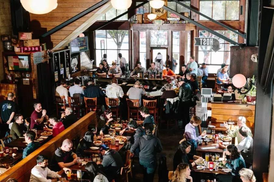 Patrons eat and drink inside the 21st Amendment Brewery in San Francisco.